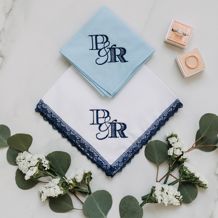 Custom embroidered wedding monogram in navy on white handkerchief with navy lace.