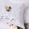 Handwriting embroidered on a white linen pillowcase in black thread. 