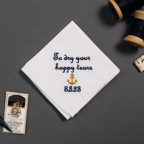 Happy tear white handkerchief with embroidered message, personalized date and anchor in gold.