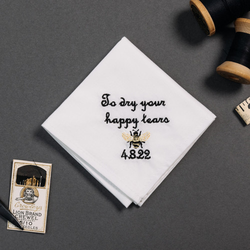 Happy tear white handkerchief with embroidered message, personalized date and bee in gold, black and white.