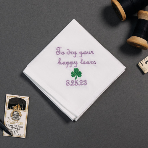 Happy tear white handkerchief with embroidered message, personalized date and shamrock in green.