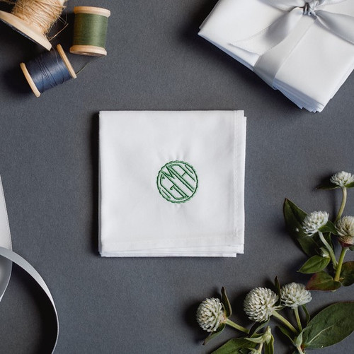 Men's monogrammed handkerchief with small circle monogram. The handkerchief is embroidered with a green monogram.