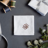 Monogrammed men's white handkerchief with elegant embroidered monogram in merlot color embroidery thread.