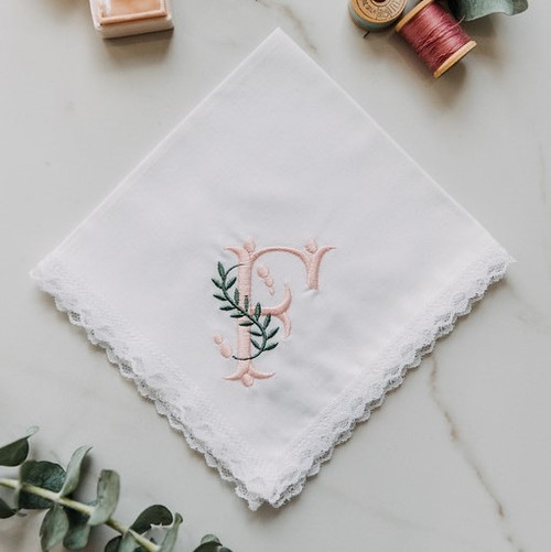 Monogrammed women's handkerchief with large initial and berry and vine design. Embroidery is is blush and sage green thread.