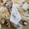 Embroidered initial handkerchief with flower bouquet and lace. Handkerchief is white with blush initial and sage color vines.