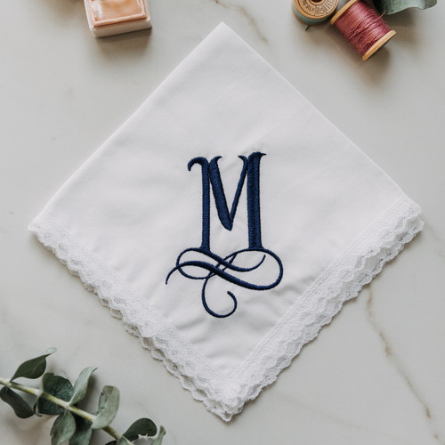 Monogrammed women's handkerchief with large initial. Embroidery is is shown in navy blue on our Dainty White Lace handkerchief. Customer can enter their own initial and pick their embroidery color.