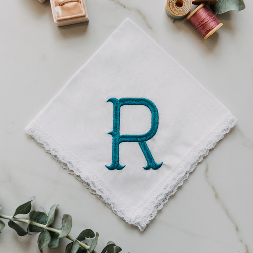 Monogrammed women's handkerchief with large initial in Fish Hook. Embroidery is is shown in peacock. Customer can enter their own initial and pick their embroidery color.