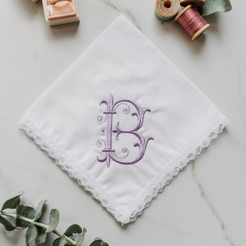 Monogrammed women's handkerchief with large medieval initial. Embroidery is is shown in lavender on our Dainty White handkerchief style. Customer can enter their own initial and pick their embroidery color.