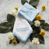 Something Blue embroidered handkerchief shown with men's powder blue handkerchief. Both are embroidered with powder blue embroidery thread.